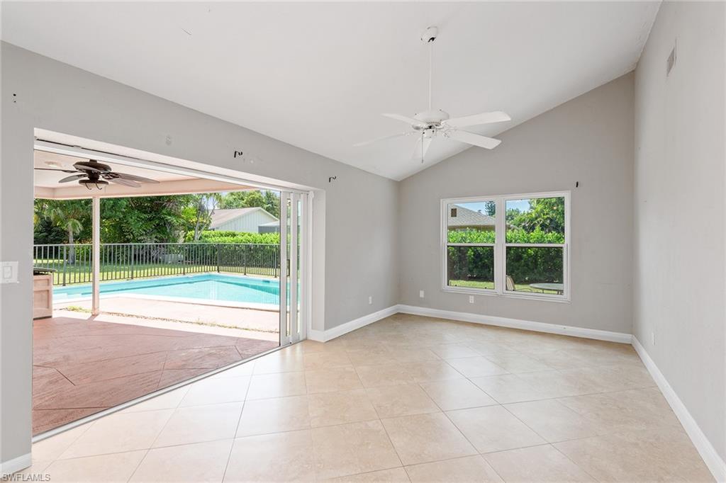 280 Baltusrol Drive Naples, FL 34113 - Photo 2 of 13 a view of an empty room with a window and ceiling fan