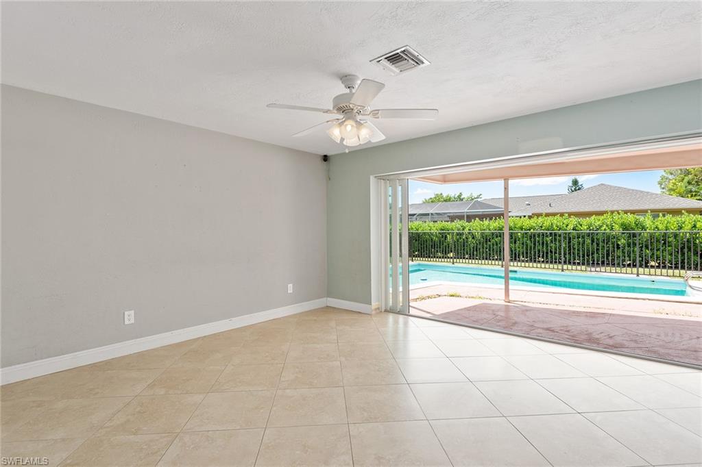 280 Baltusrol Drive Naples, FL 34113 - Photo 3 of 13 a view of an empty room with a window and a ceiling fan