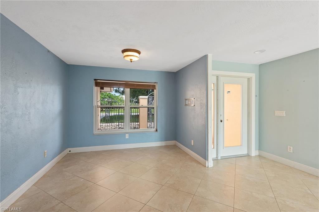 280 Baltusrol Drive Naples, FL 34113 - Photo 5 of 13 a view of an empty room with a window