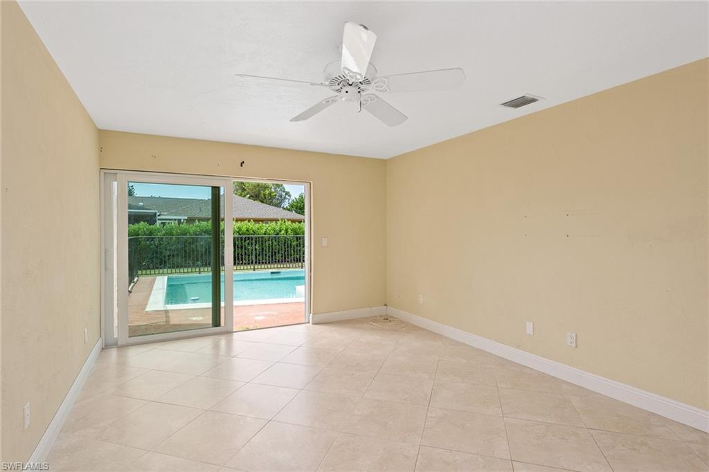 280 Baltusrol Drive Naples, FL 34113 - Photo 6 of 13 a view of an empty room with a window