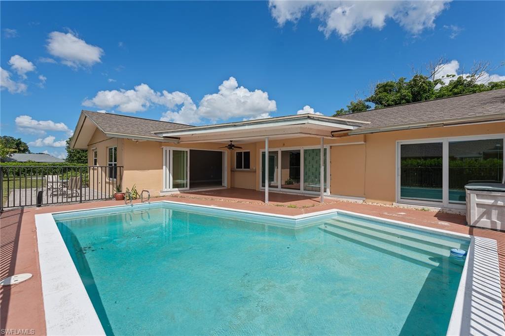 280 Baltusrol Drive Naples, FL 34113 - Photo 10 of 13 a view of a house with a yard porch and sitting area