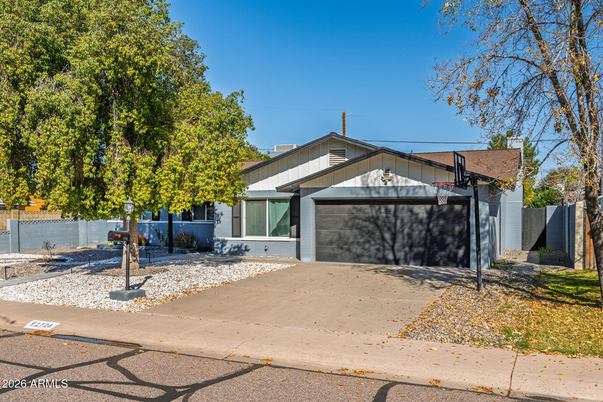 1726 West Royal Palm Road Phoenix, AZ 85021 - Photo 19 of 20 a front view of a house with a yard and garage