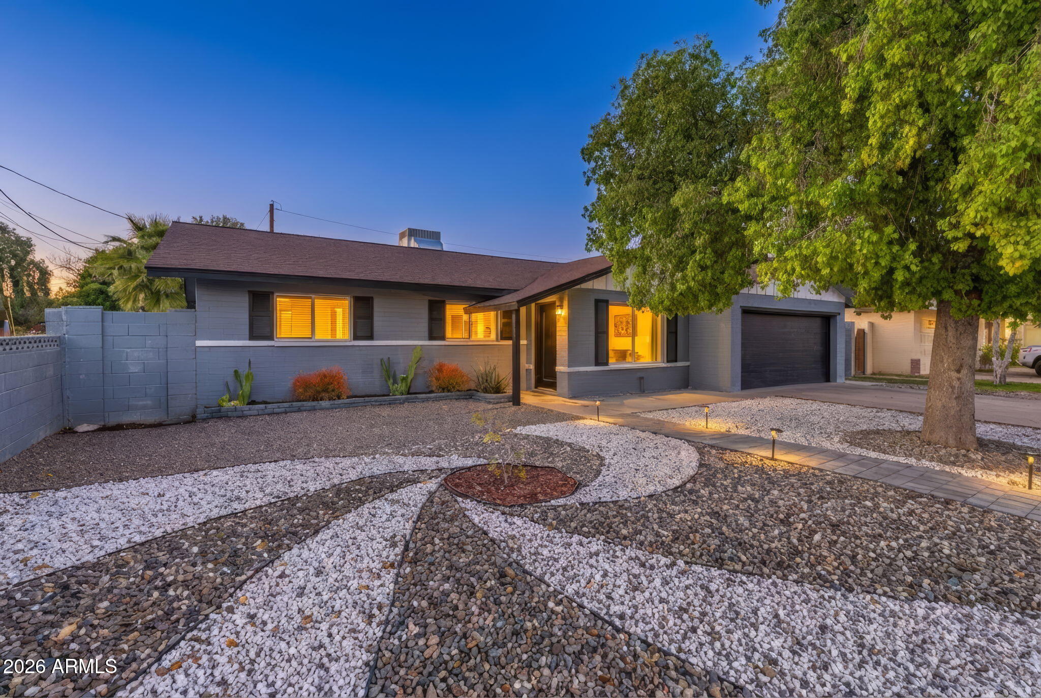 1726 West Royal Palm Road Phoenix, AZ 85021 - Photo 2 of 20 a front view of a house with a yard and a garage