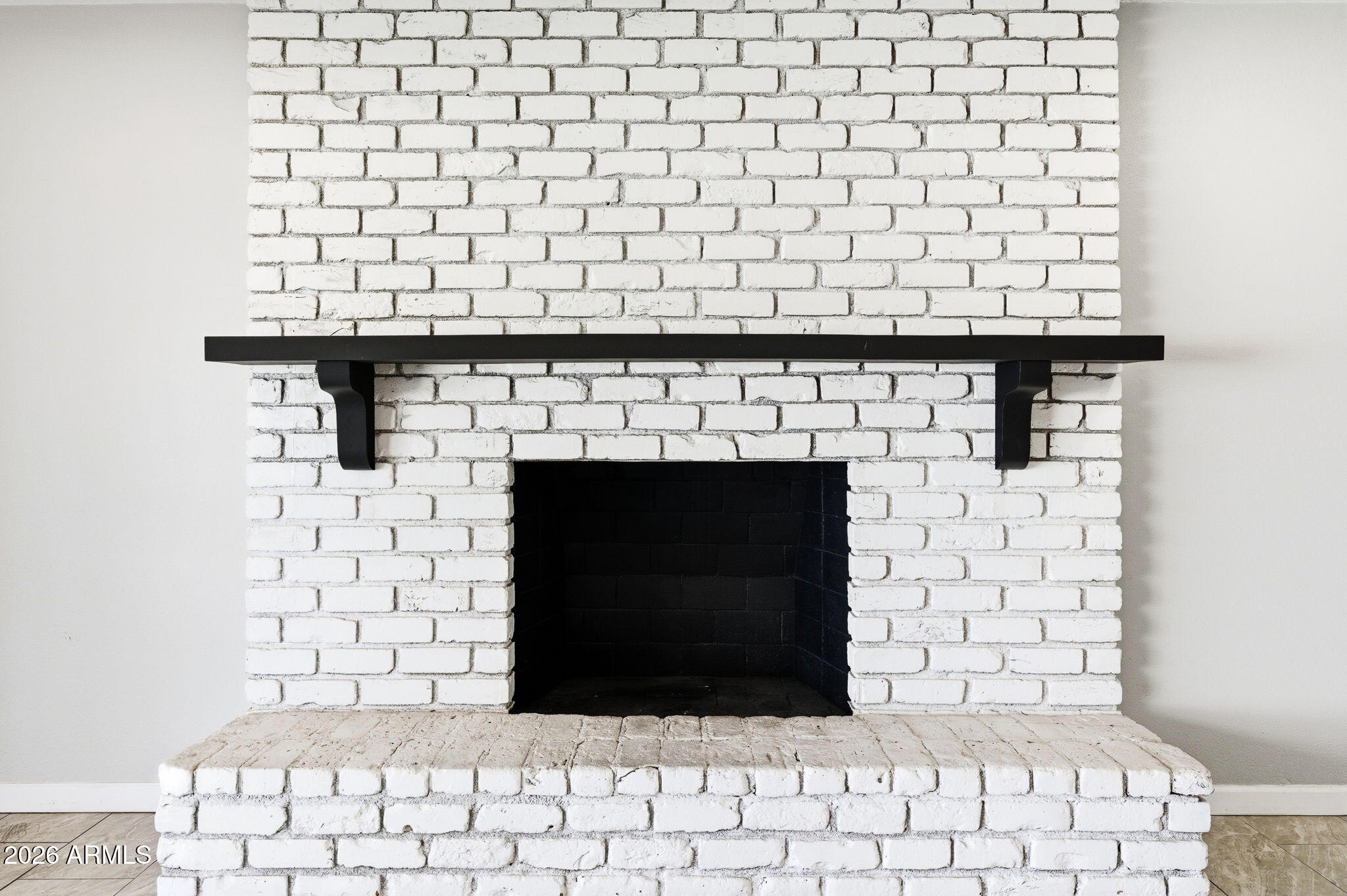 1726 West Royal Palm Road Phoenix, AZ 85021 - Photo 5 of 20 a room with a brick wall and fireplace
