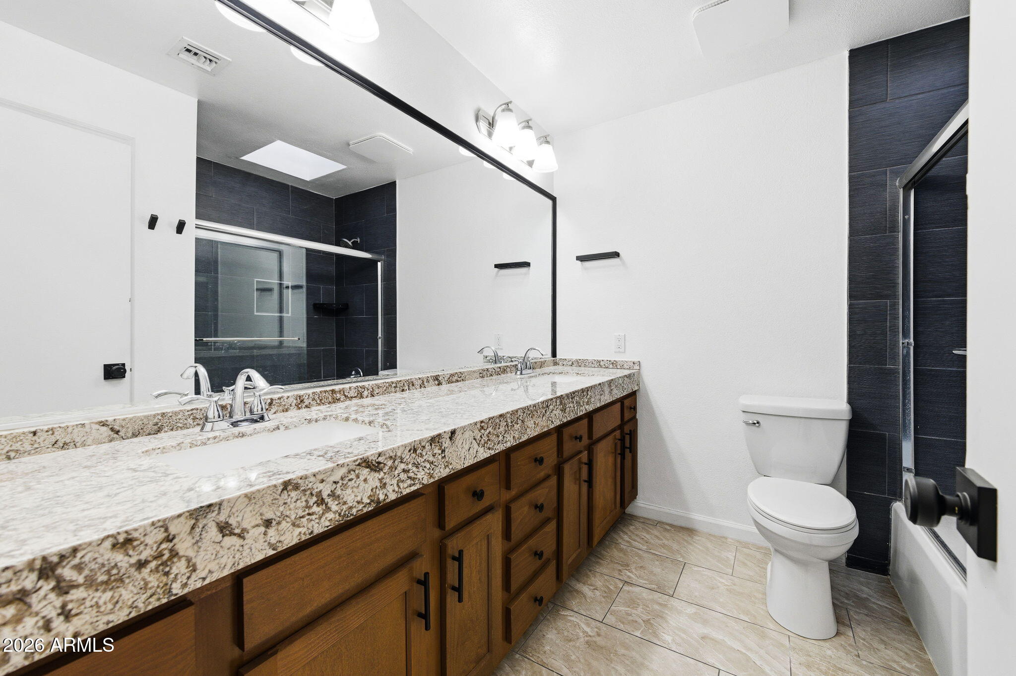 1726 West Royal Palm Road Phoenix, AZ 85021 - Photo 8 of 20 a bathroom with a granite countertop sink a toilet and a mirror