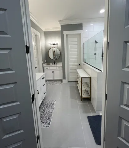 a bathroom with a sink a mirror and shower