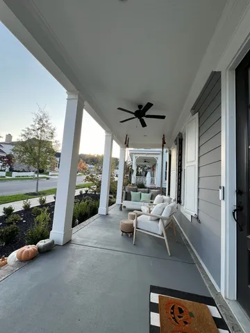 a living room with patio furniture and a floor to ceiling window