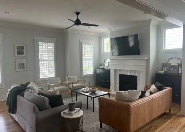 a living room with furniture fireplace and flat screen tv