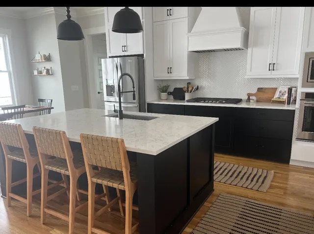 a kitchen with stainless steel appliances kitchen island granite countertop a sink and cabinets