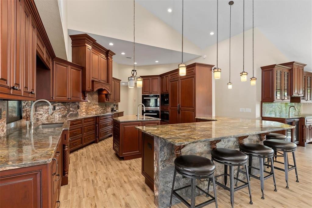 1701 Casey Key Drive Punta Gorda, FL 33950 - Photo 11 of 58 a kitchen with stainless steel appliances granite countertop a table chairs stove and refrigerator