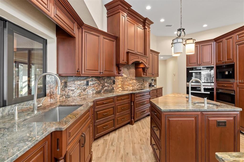 1701 Casey Key Drive Punta Gorda, FL 33950 - Photo 12 of 58 a kitchen with stainless steel appliances granite countertop a sink a stove and a refrigerator