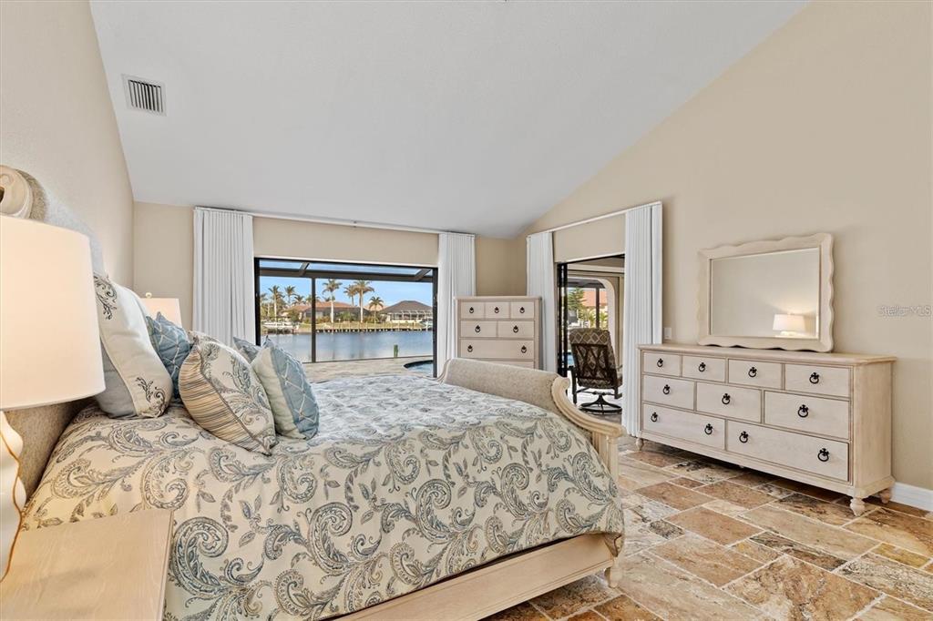 1701 Casey Key Drive Punta Gorda, FL 33950 - Photo 15 of 58 a bedroom with a large bed and a dresser