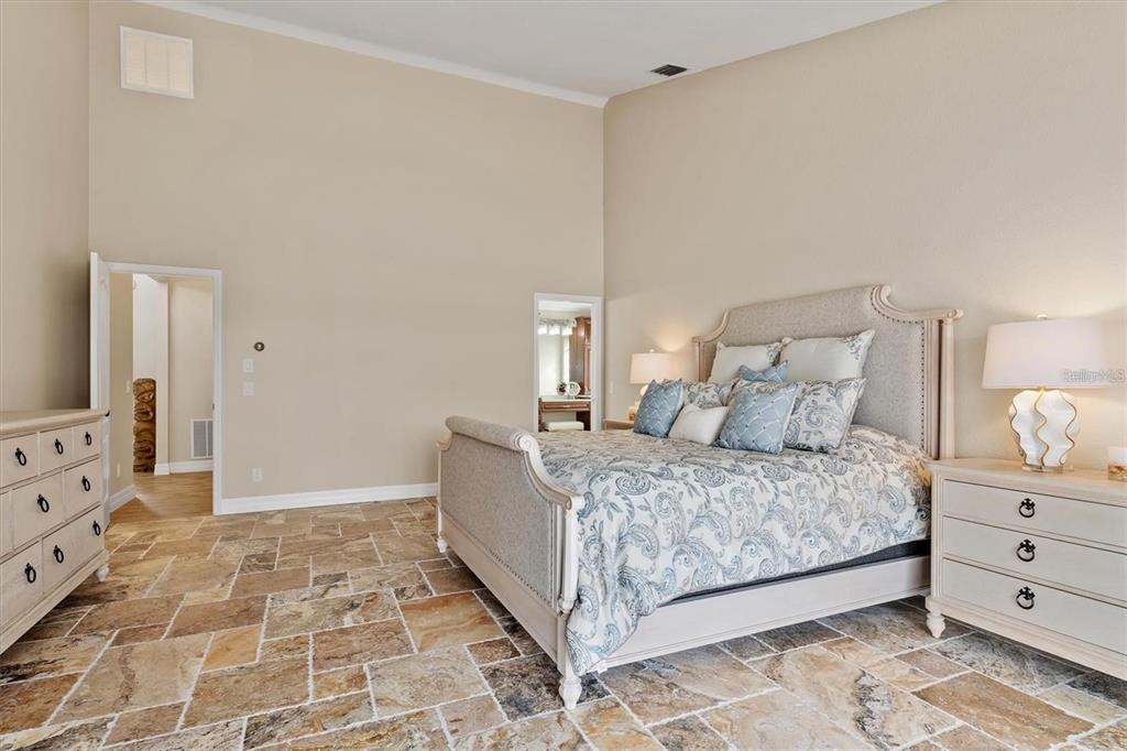 1701 Casey Key Drive Punta Gorda, FL 33950 - Photo 16 of 58 a room with a bed and mirror