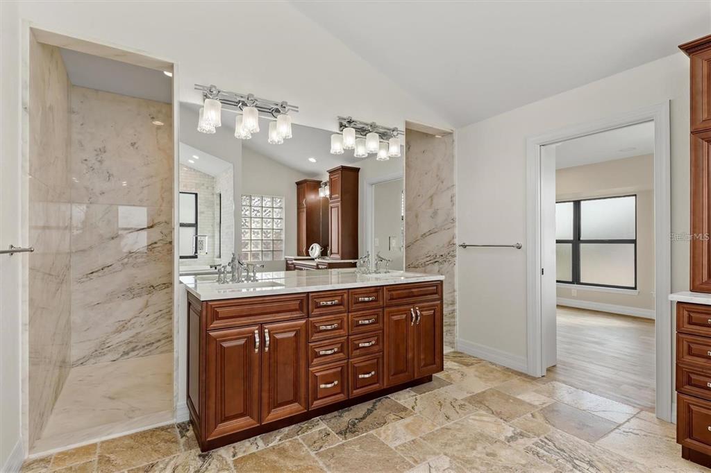 1701 Casey Key Drive Punta Gorda, FL 33950 - Photo 18 of 58 a spacious bathroom with a double vanity sink and a mirror