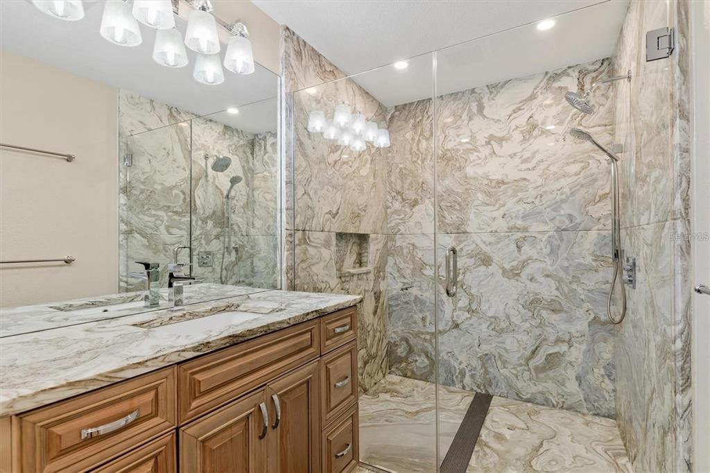 1701 Casey Key Drive Punta Gorda, FL 33950 - Photo 25 of 58 a bathroom with a granite countertop sink a shower and a mirror