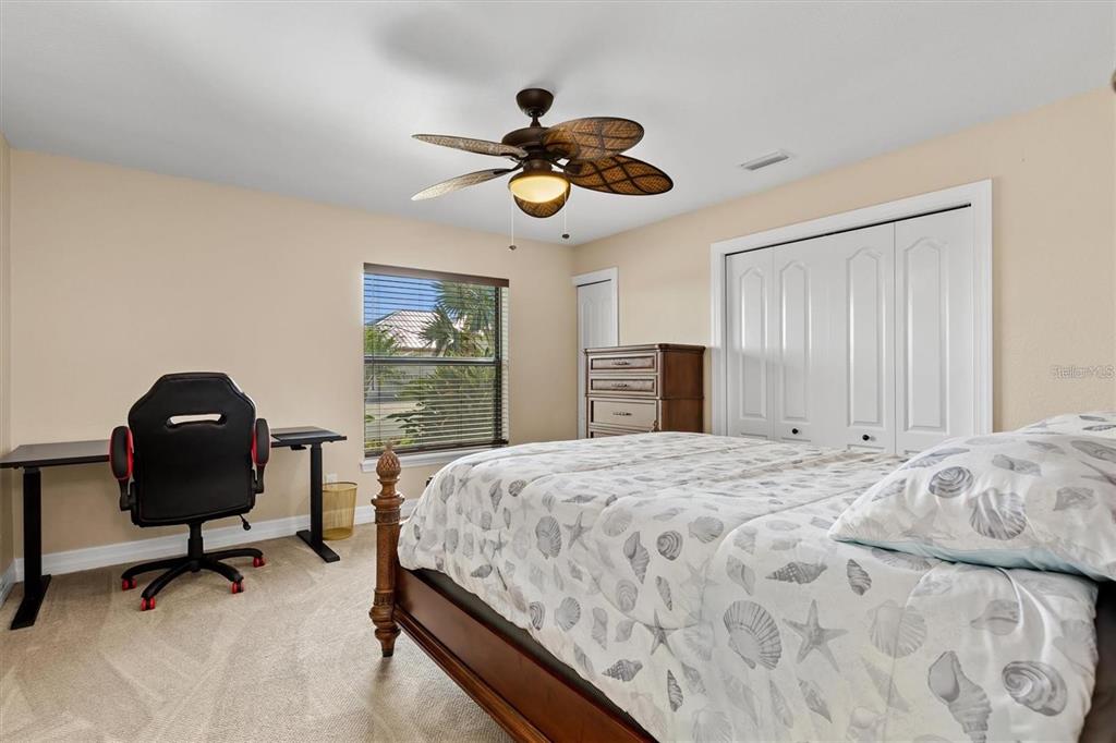 1701 Casey Key Drive Punta Gorda, FL 33950 - Photo 26 of 58 a bedroom with a bed and a chandelier