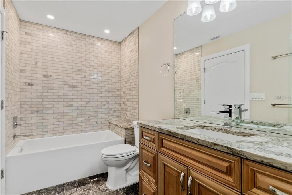 1701 Casey Key Drive Punta Gorda, FL 33950 - Photo 28 of 58 a bathroom with a granite countertop sink toilet and shower
