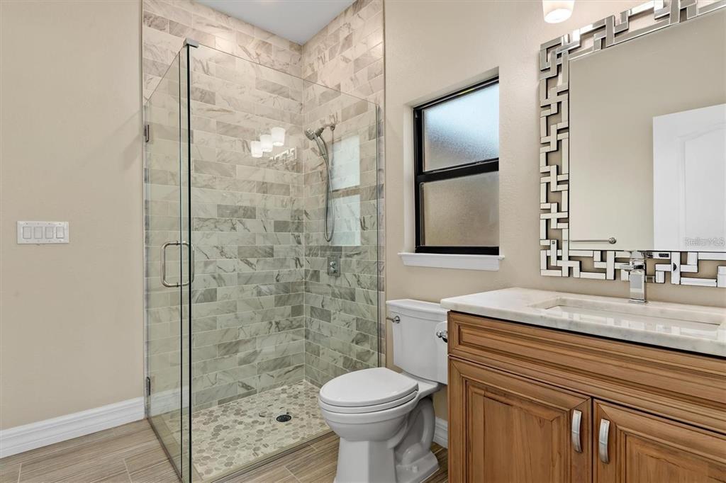 1701 Casey Key Drive Punta Gorda, FL 33950 - Photo 31 of 58 a bathroom with a granite countertop sink toilet and shower