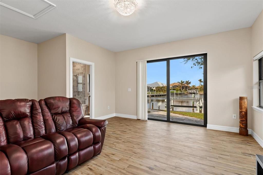 1701 Casey Key Drive Punta Gorda, FL 33950 - Photo 32 of 58 a living room with furniture and wooden floor