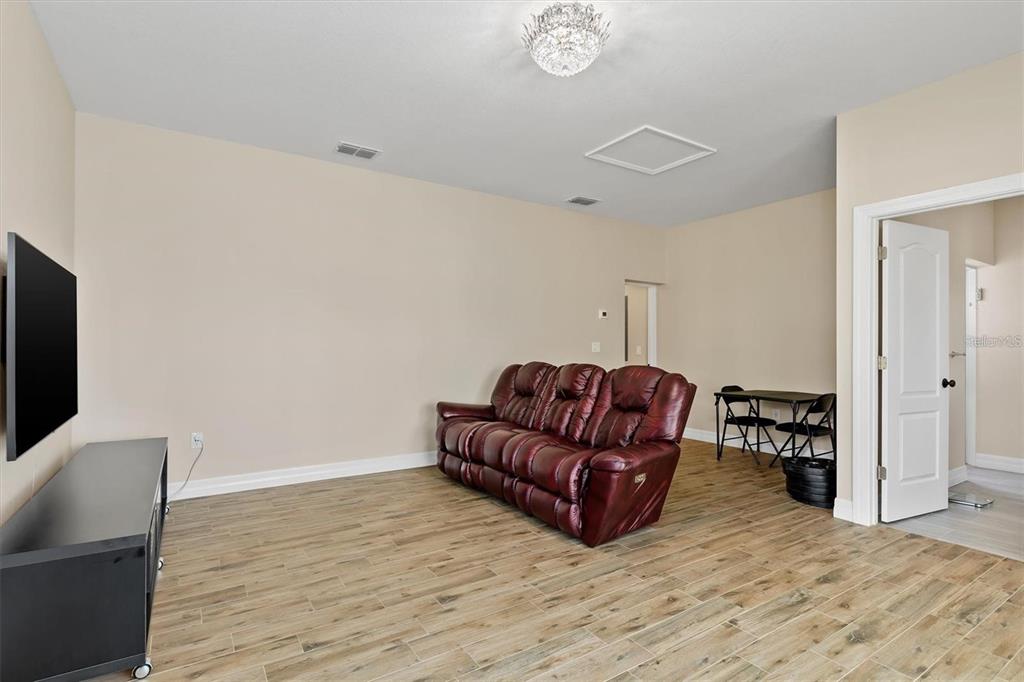 1701 Casey Key Drive Punta Gorda, FL 33950 - Photo 33 of 58 a living room with furniture and a flat screen tv