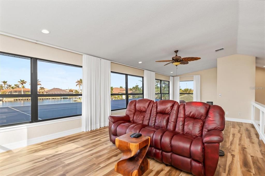 1701 Casey Key Drive Punta Gorda, FL 33950 - Photo 35 of 58 a living room with furniture and a floor to ceiling window