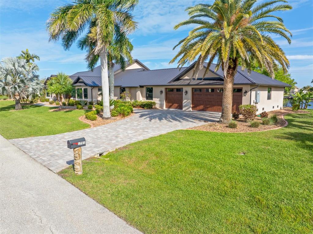 1701 Casey Key Drive Punta Gorda, FL 33950 - Photo 58 of 58 a front view of a house with garden and patio