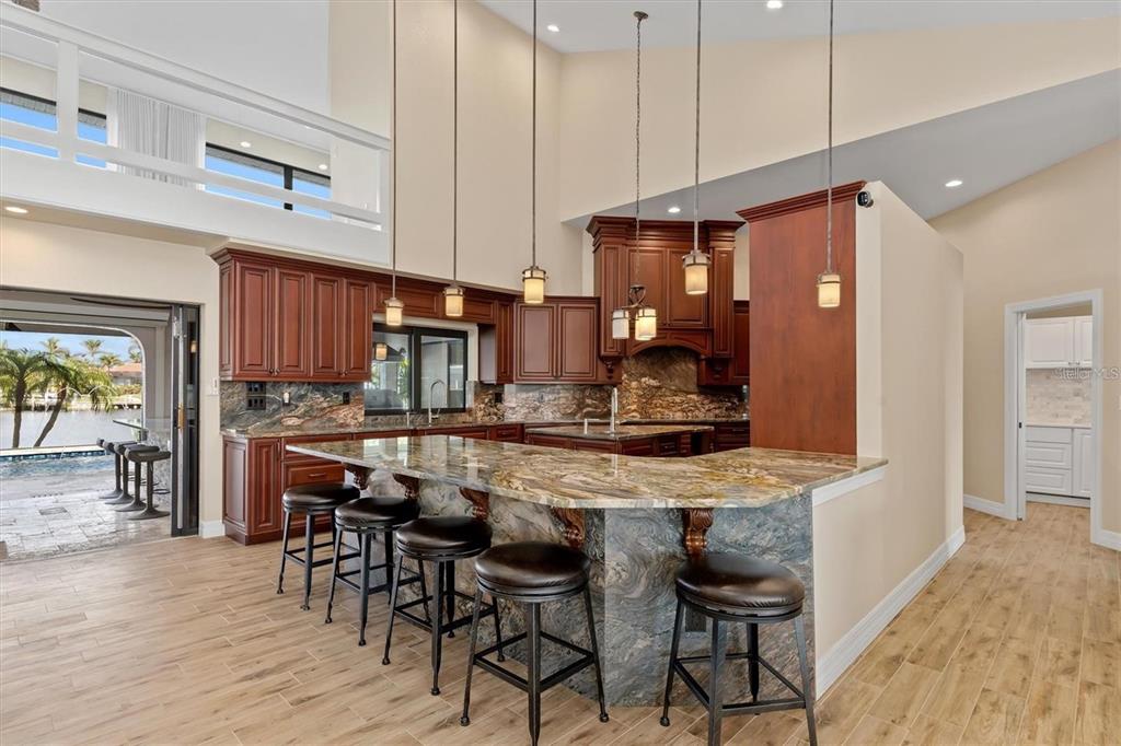 1701 Casey Key Drive Punta Gorda, FL 33950 - Photo 10 of 58 a kitchen with stainless steel appliances granite countertop table chairs sink and cabinets