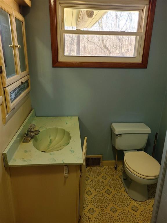 122 Logan Road New Castle, PA 16102 - Photo 5 of 17 a bathroom with a sink a toilet and a window