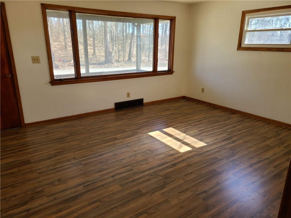 122 Logan Road New Castle, PA 16102 - Photo 7 of 17 a view of empty room with wooden floor and fan