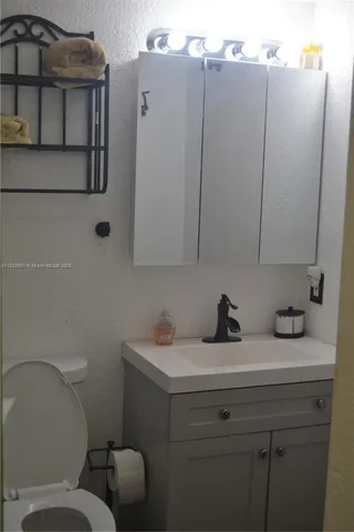 a bathroom with a toilet sink and mirror