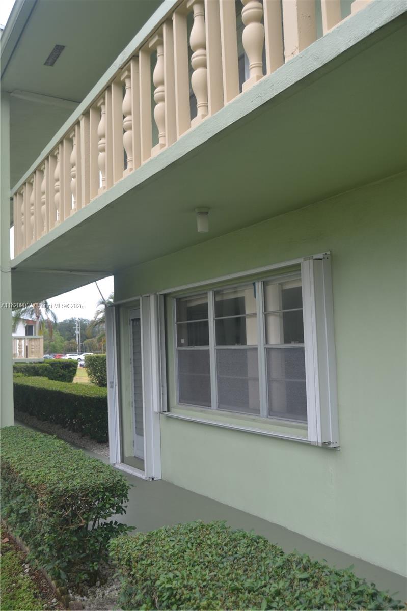 56 Norwich C, Unit 56 West Palm Beach, FL 33417 - Photo 18 of 23 a front view of a house with a yard