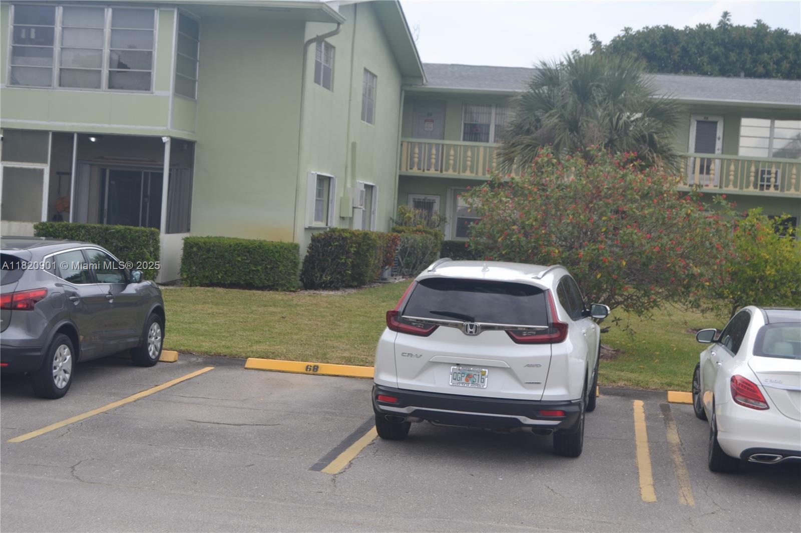 56 Norwich C, Unit 56 West Palm Beach, FL 33417 - Photo 20 of 23 a car parked in front of a house