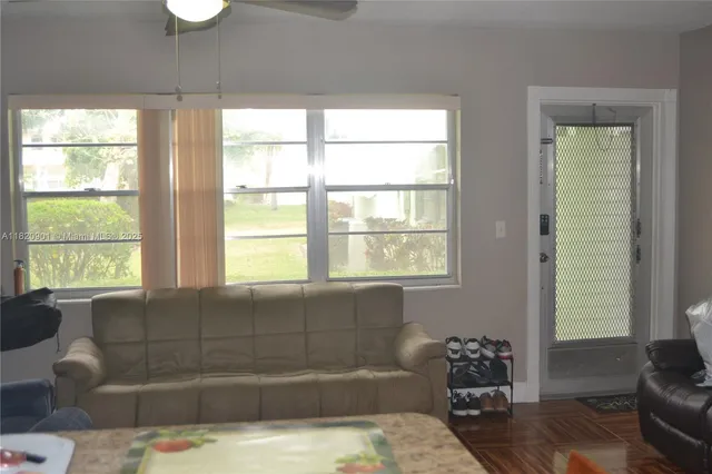 a bathroom with a bathtub and next to a window
