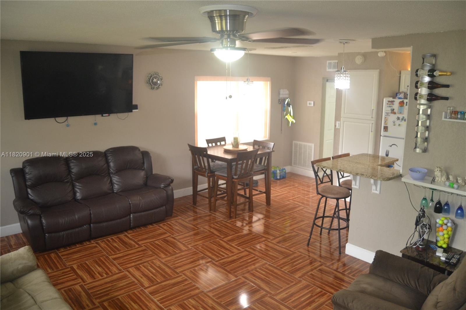 56 Norwich C, Unit 56 West Palm Beach, FL 33417 - Photo 5 of 23 a living room with furniture and a flat screen tv