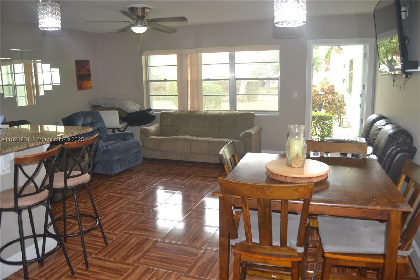 56 Norwich C, Unit 56 West Palm Beach, FL 33417 - Photo 7 of 23 a living room with furniture and a window