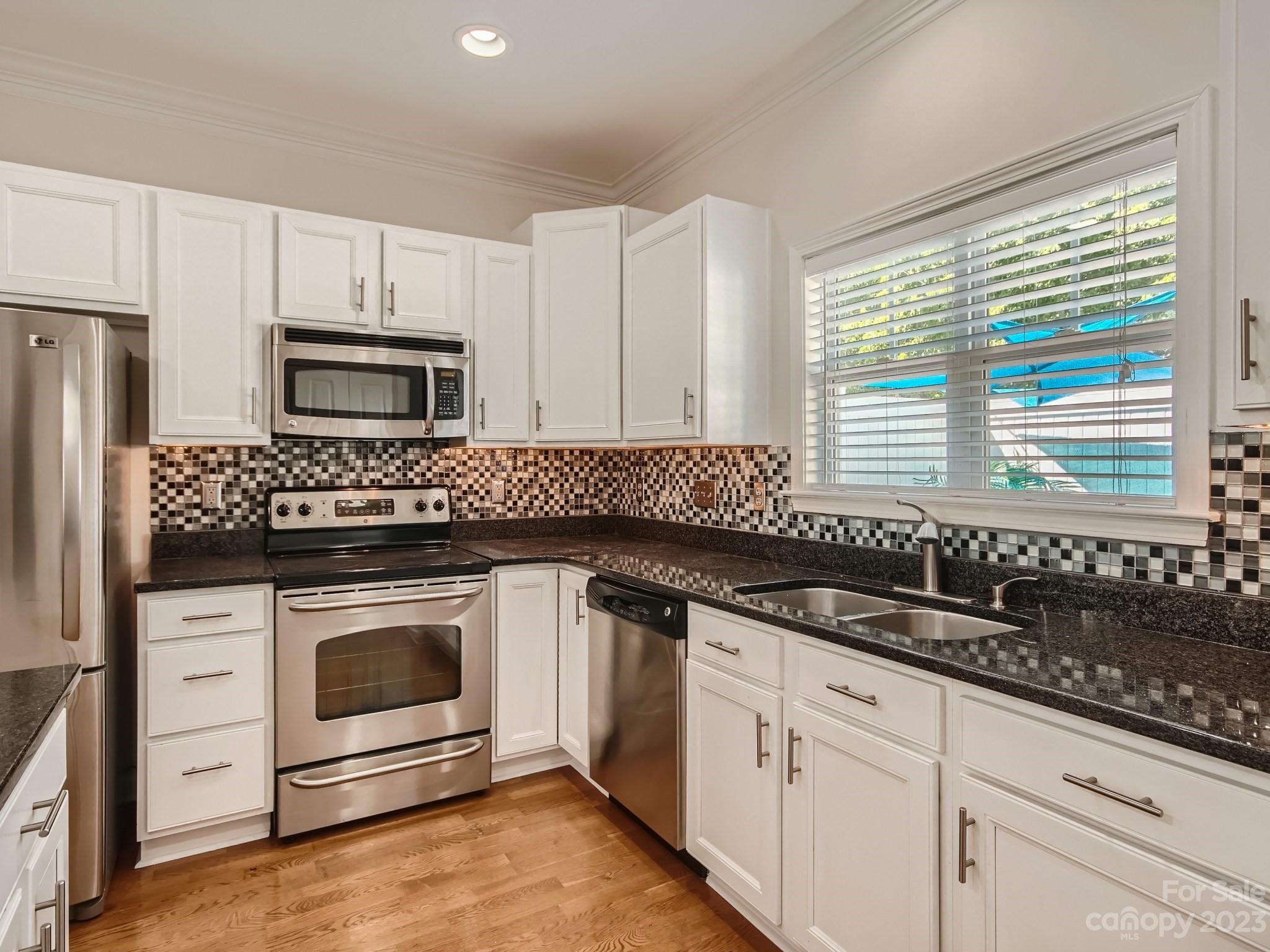 4130 Walker Road Charlotte, NC 28211 - Photo 12 of 28 a kitchen with granite countertop a sink and a stove