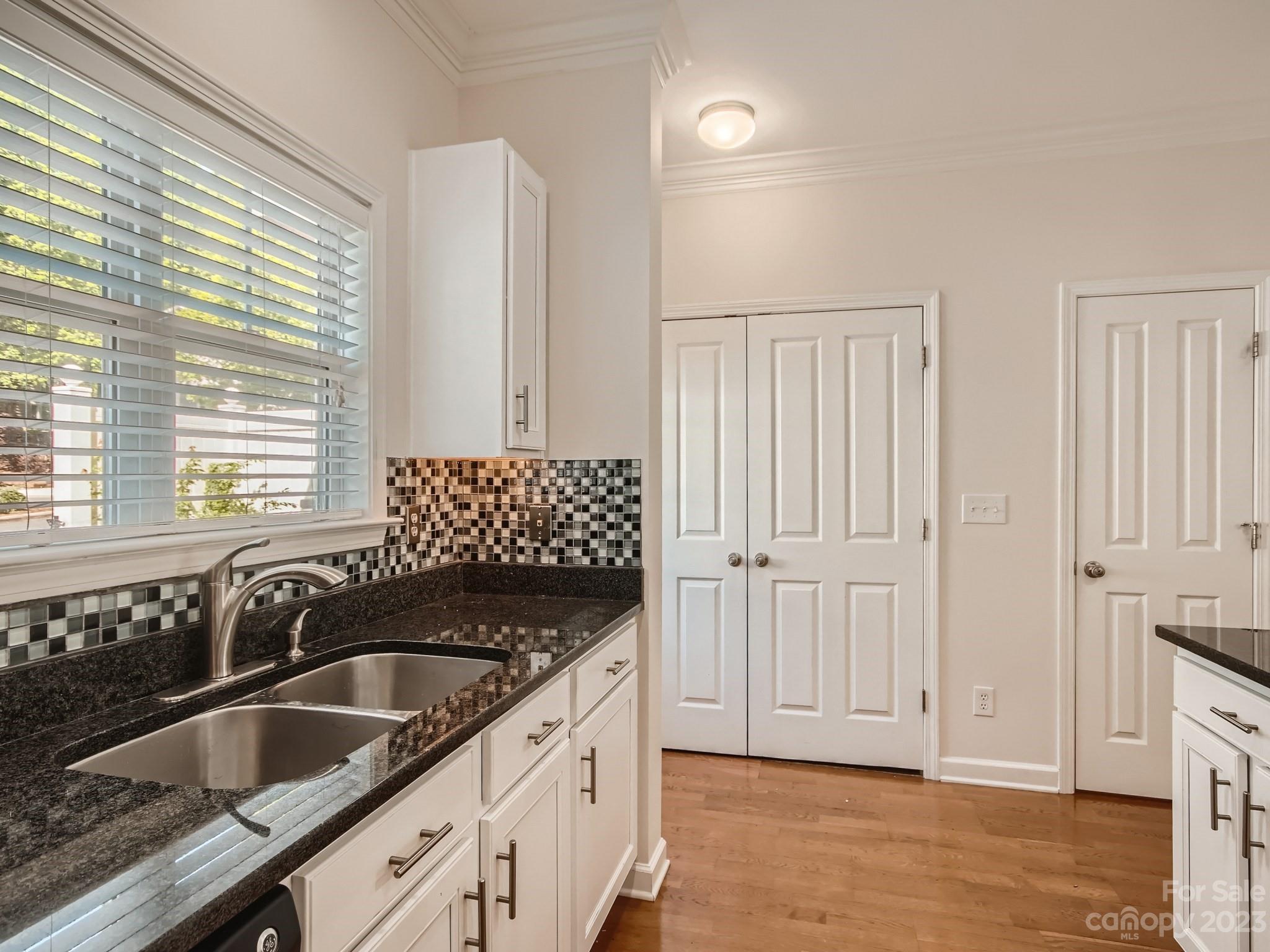 4130 Walker Road Charlotte, NC 28211 - Photo 13 of 28 a kitchen with granite countertop a sink and a white wooden cabinets