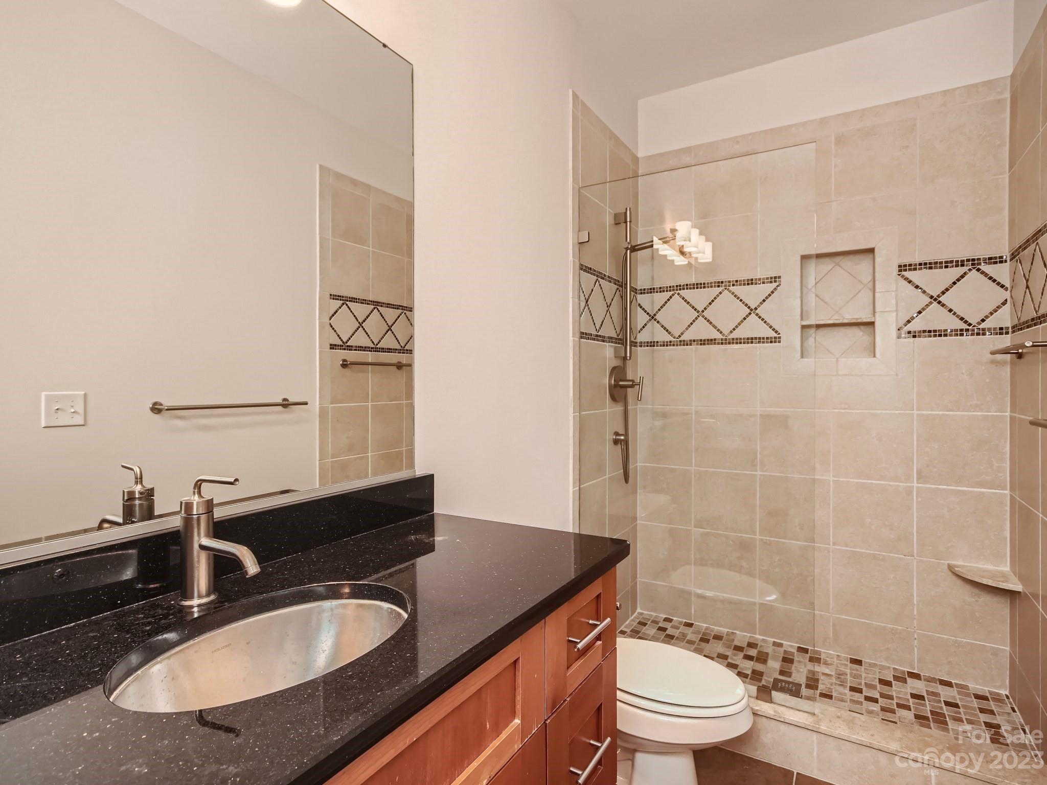 4130 Walker Road Charlotte, NC 28211 - Photo 20 of 28 a bathroom with a sink a toilet and shower