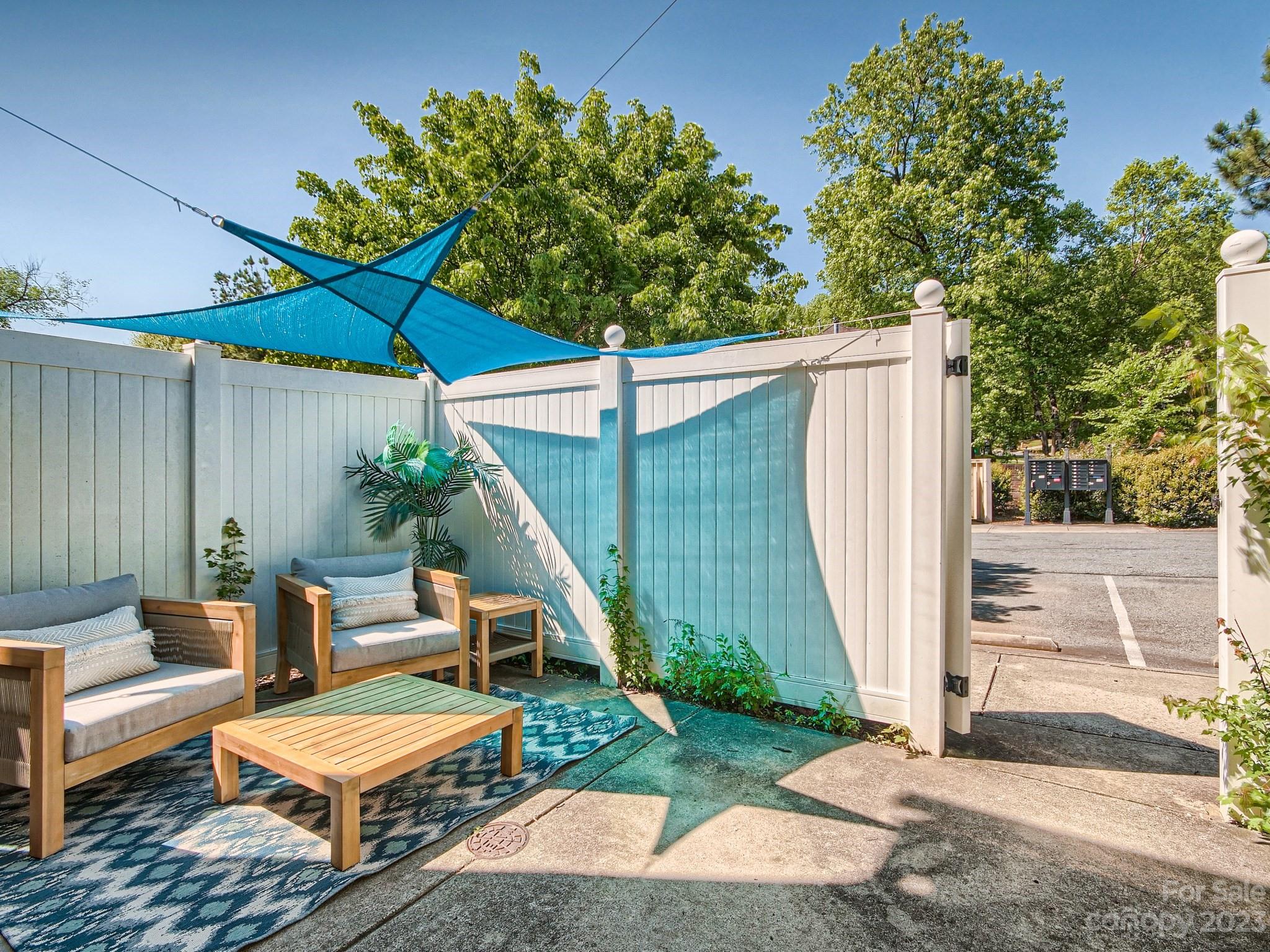 4130 Walker Road Charlotte, NC 28211 - Photo 26 of 28 a view of patio with a table and chairs under an umbrella with wooden fence