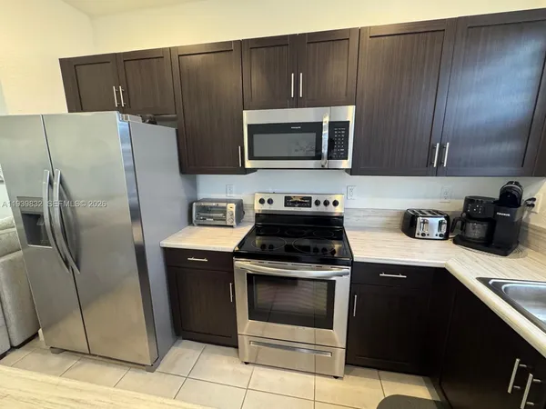 a kitchen with a stove microwave and refrigerator