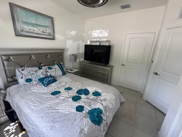 a bedroom with a bed and a television