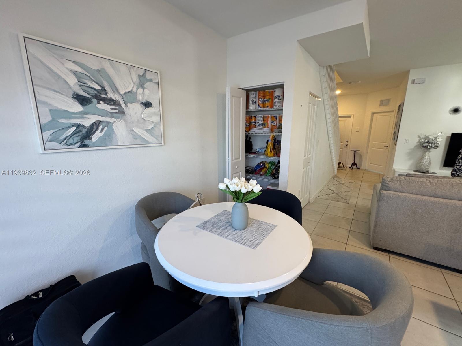 18236 Southwest 148th Road Miami, FL 33187 - Photo 5 of 9 a dining room with a couch and a table