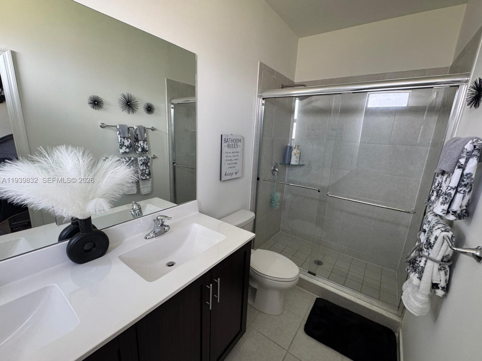 18236 Southwest 148th Road Miami, FL 33187 - Photo 8 of 9 a bathroom with a sink toilet and shower