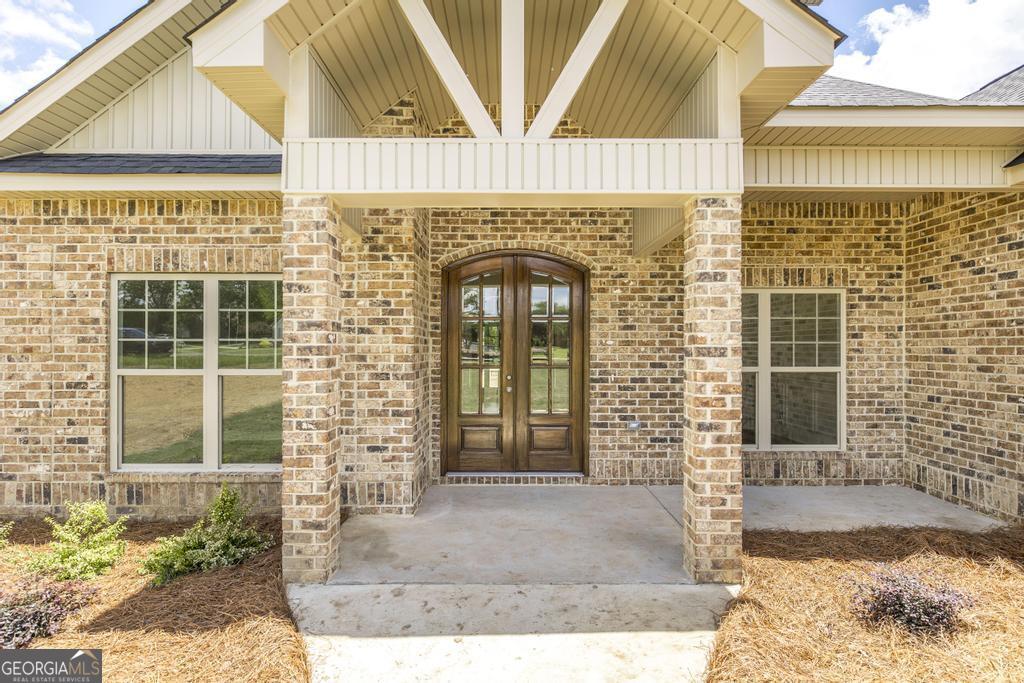 3563 Housers Mill Road Byron, GA 31008 - Photo 2 of 10 a front view of a house with a garden