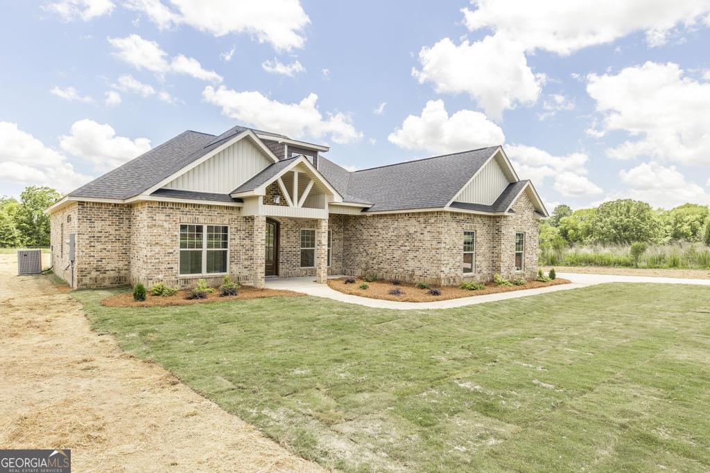3563 Housers Mill Road Byron, GA 31008 - Photo 3 of 10 a view of a house with a yard and garage