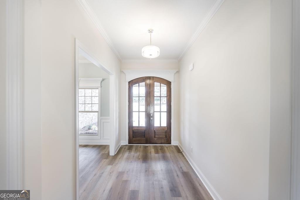 3563 Housers Mill Road Byron, GA 31008 - Photo 5 of 10 an empty room with wooden floor and windows