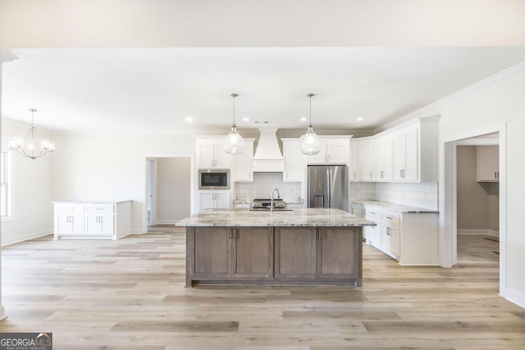 3563 Housers Mill Road Byron, GA 31008 - Photo 6 of 10 a large white kitchen with cabinets and wooden floor