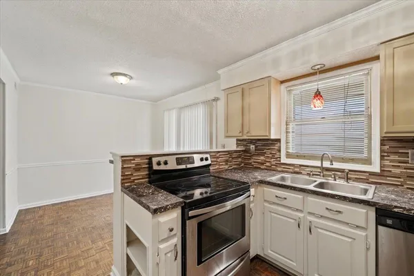 a kitchen with a stove and a sink