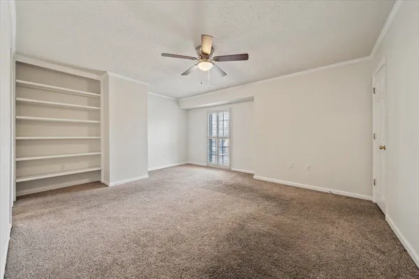 a view of an empty room with a ceiling fan