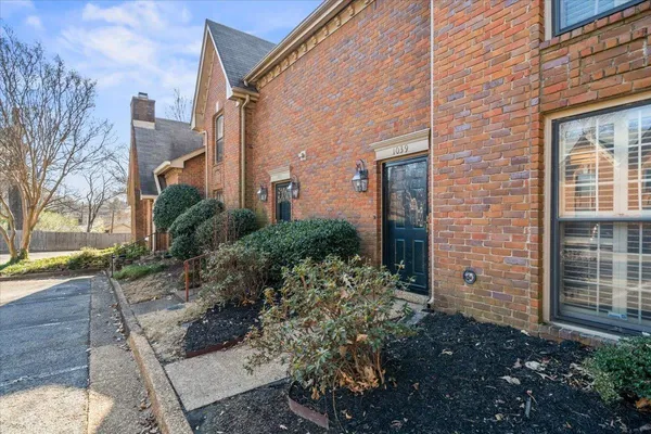 a view of a brick house many windows